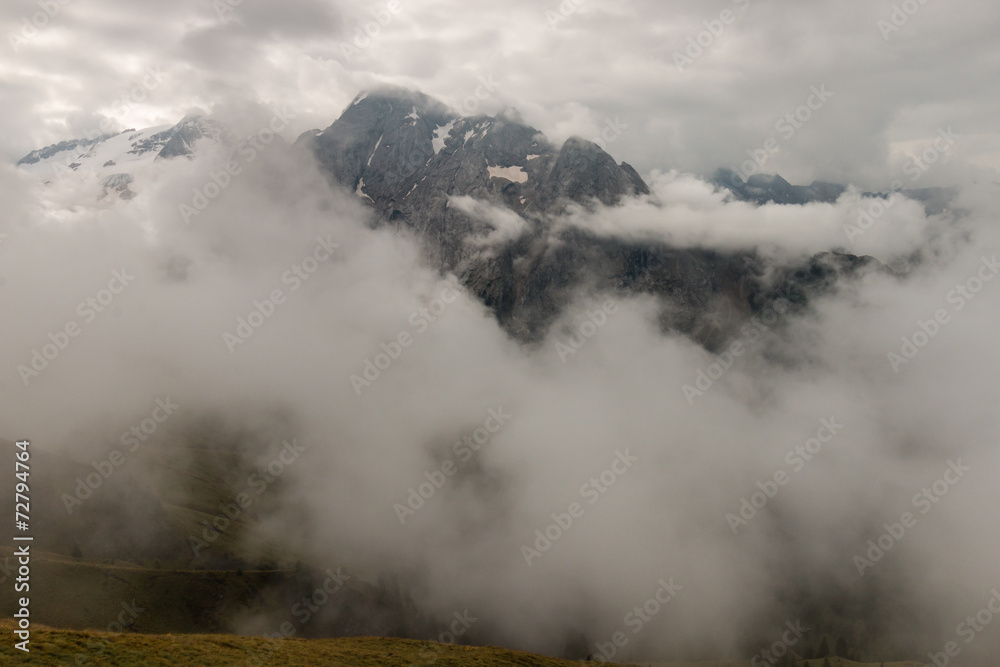 mountain range in Dolomites obscured by clouds