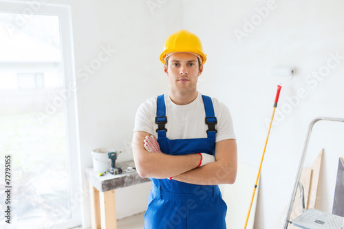 builder in hardhat with working tools indoors