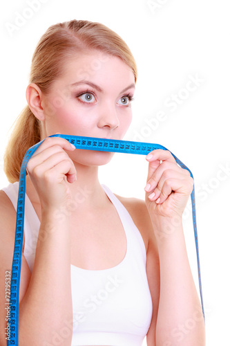 Fitness girl fit woman covering her mouth with measuring tape