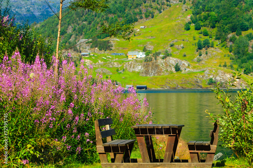 Picnic table and benches near lake in Norway, Europe.