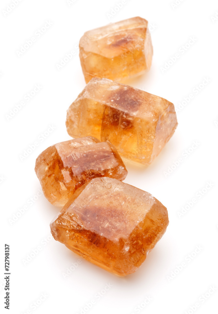Brown caramelized lump cane sugar cube isolated on white backgro Brown caramelized lump cane sugar cube isolated on white backgro