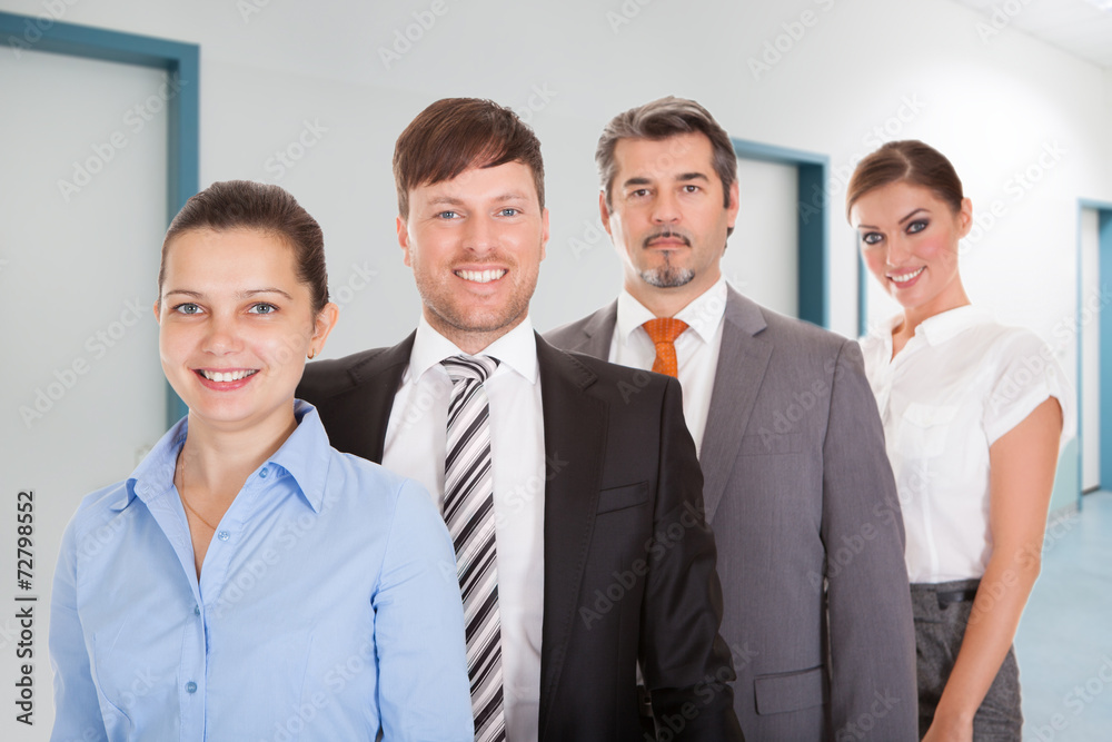 Confident Businesspeople Standing Together In Office Confident Businesspeople Standing Together In Office