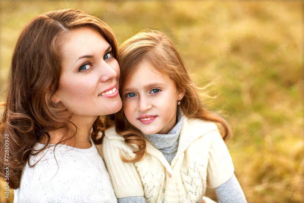 Obraz premium mother and daughter walking in autumn in a field