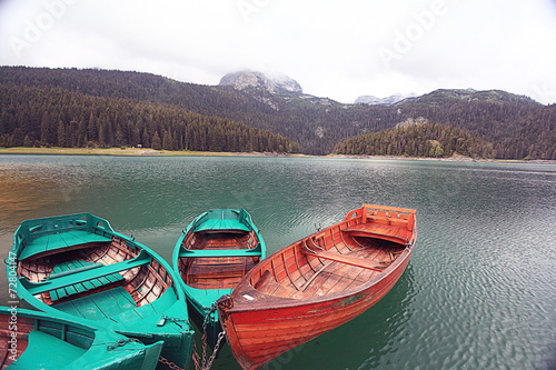 wooden boat on a mooring mountain lake photo