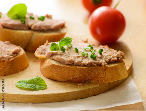 Sandwiches with paste and green onions. Served with cherry tomatoes.
