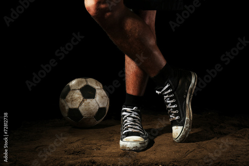 Soccer ball on ground on dark background