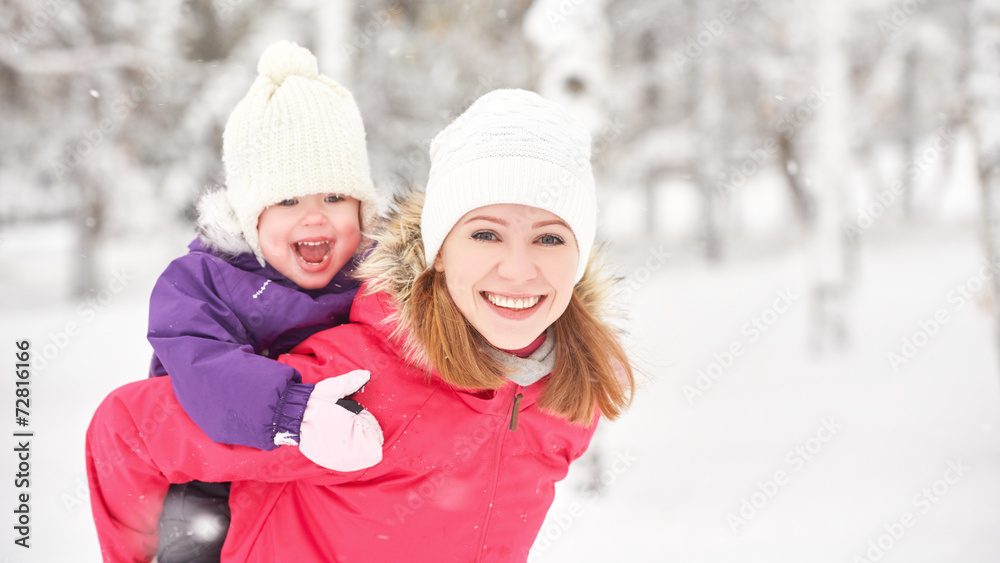 happy family mother and baby girl daughter playing in winter happy family mother and baby girl daughter playing in winter