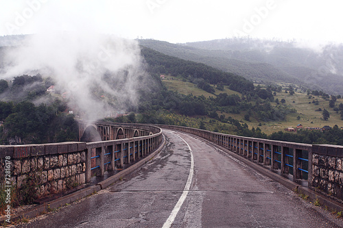 bridge in the mountains fog clouds rain