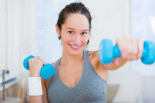 Young attractive girl doing exercise at home