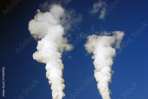 Two streams of steam in the blue sky.