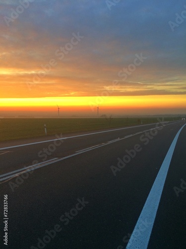 Empty road and dramatic sunset