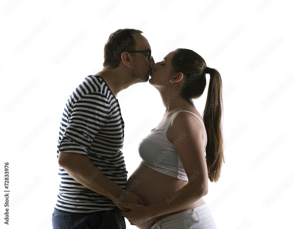 Silhouette of pregnant couple posing in studio Silhouette of pregnant couple posing in studio