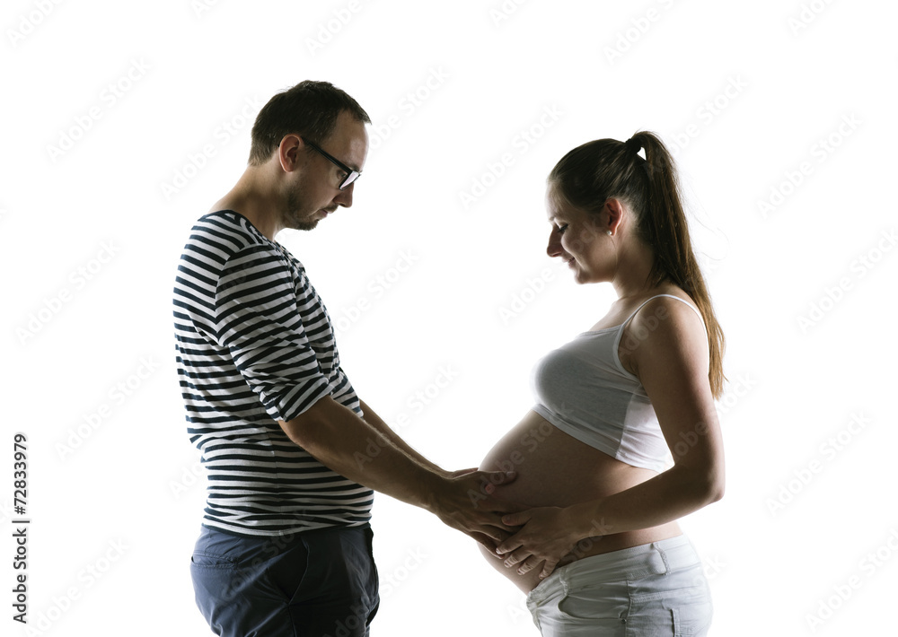 Silhouette of pregnant couple posing in studio Silhouette of pregnant couple posing in studio