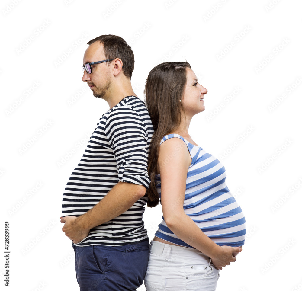 Pregnant couple posing in studio Pregnant couple posing in studio