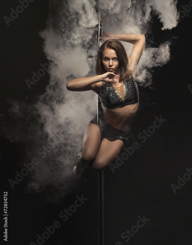 Young sexy pole dance woman.