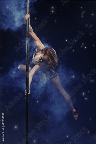 Young sexy pole dance woman.
