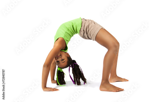 Young baby artistic gymnast doing bridge, isolated