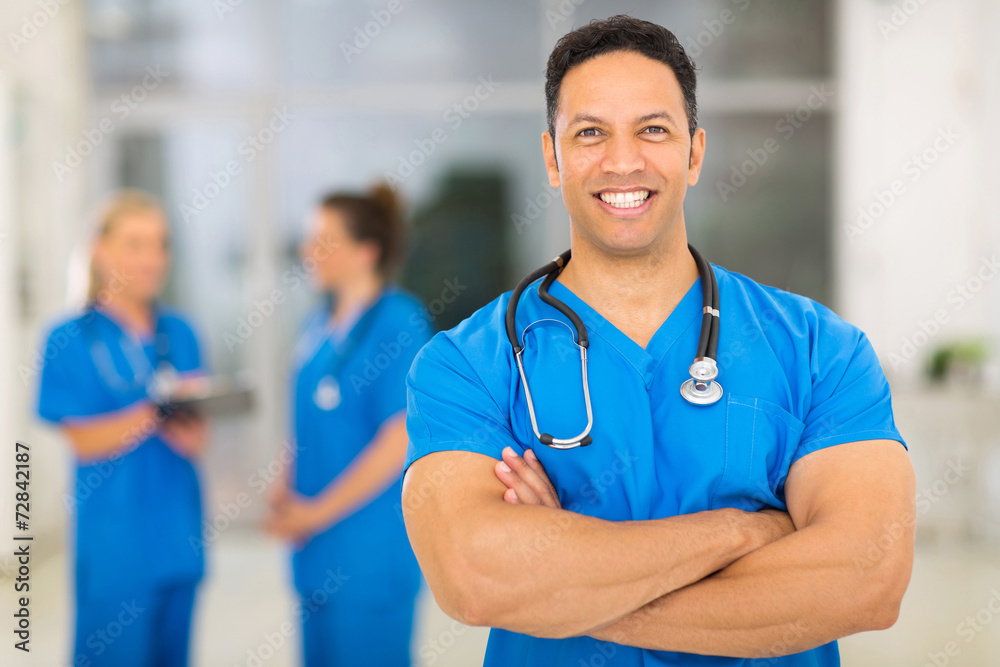 middle aged medical doctor with arms crossed in clinic middle aged medical doctor with arms crossed in clinic