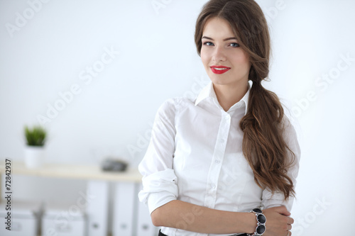 Attractive businesswoman standing in office