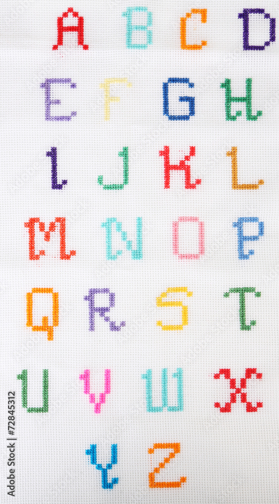 Fototapeta premium Handmade embroidered letters on white fabric background