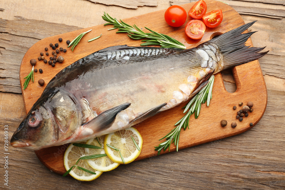 Fresh raw fish and food ingredients on table Fresh raw fish and food ingredients on table