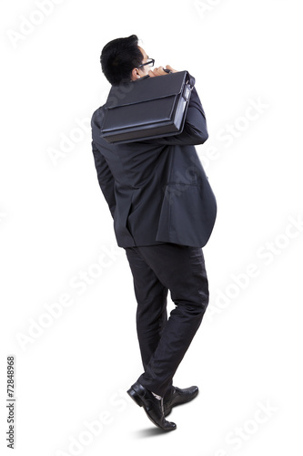 Businessperson carrying briefcase in studio