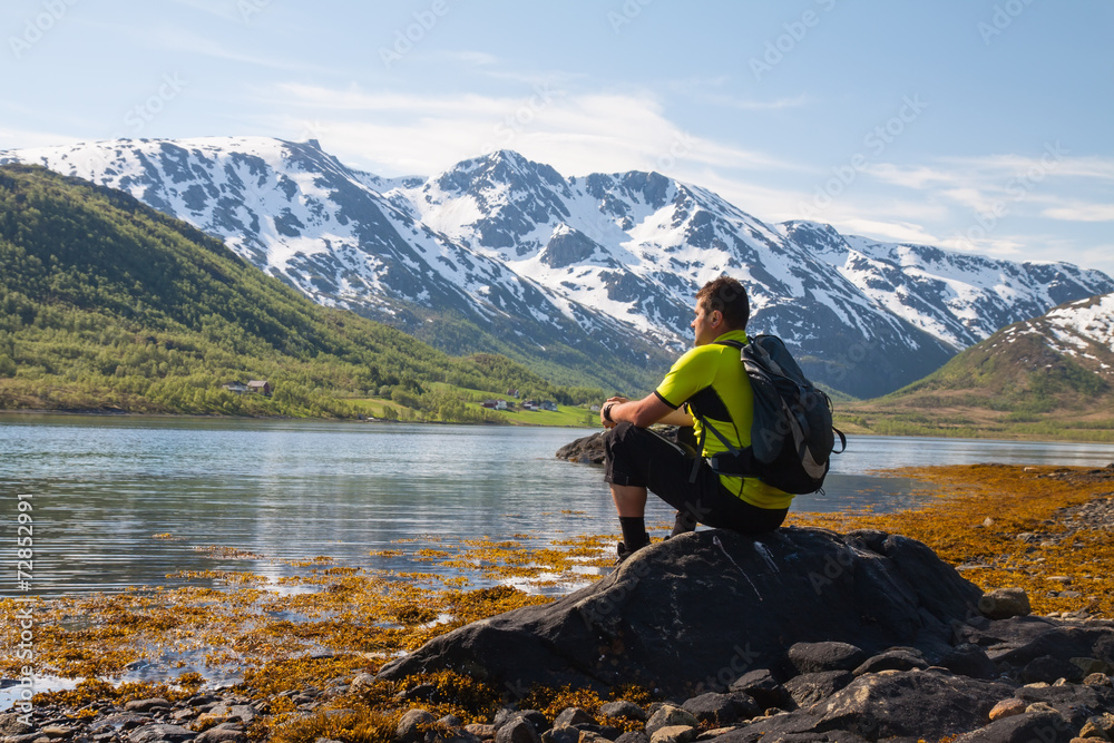 Sportsman near mountain lake