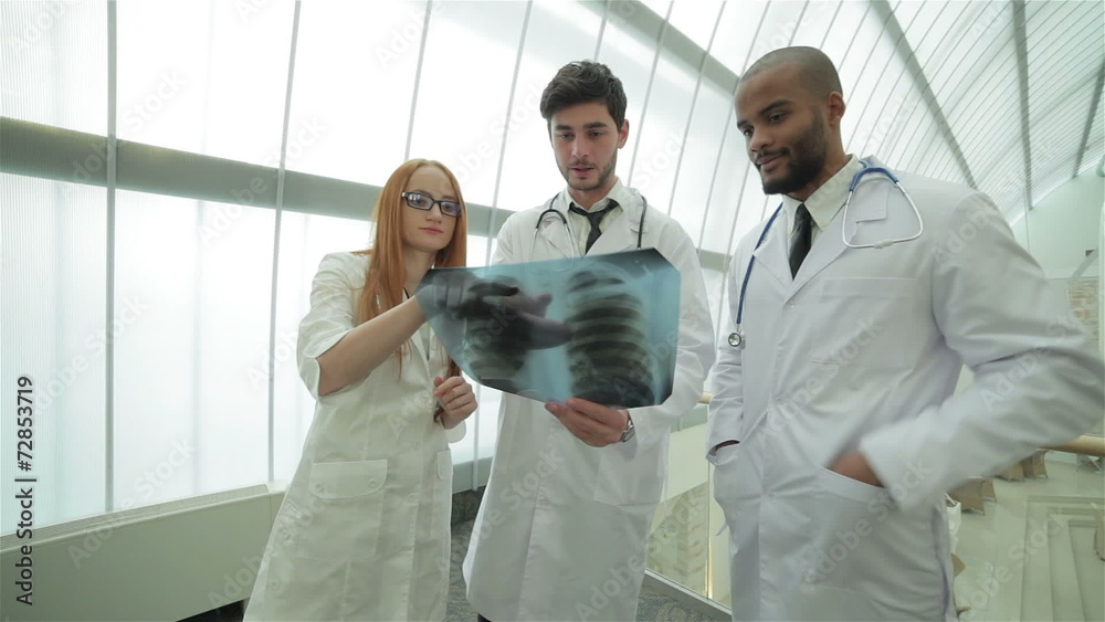 Confident doctor examining x-ray snapshot of lungs in hospital