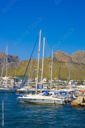 Yacht in harbor and mountains of Port de Pollenca, Mallorca