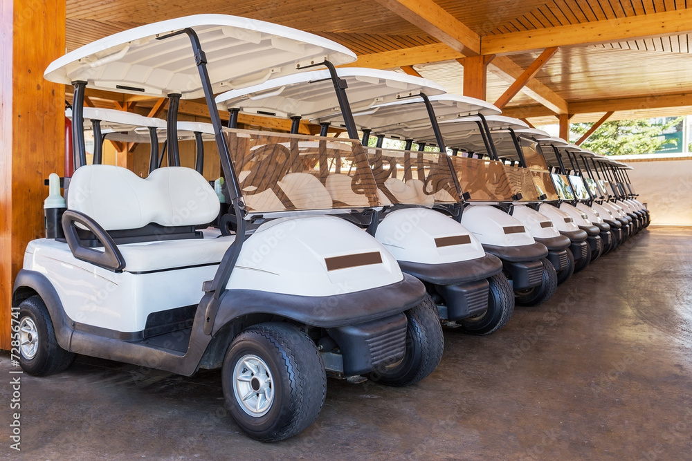 Golf buggy parked. Many in a row.