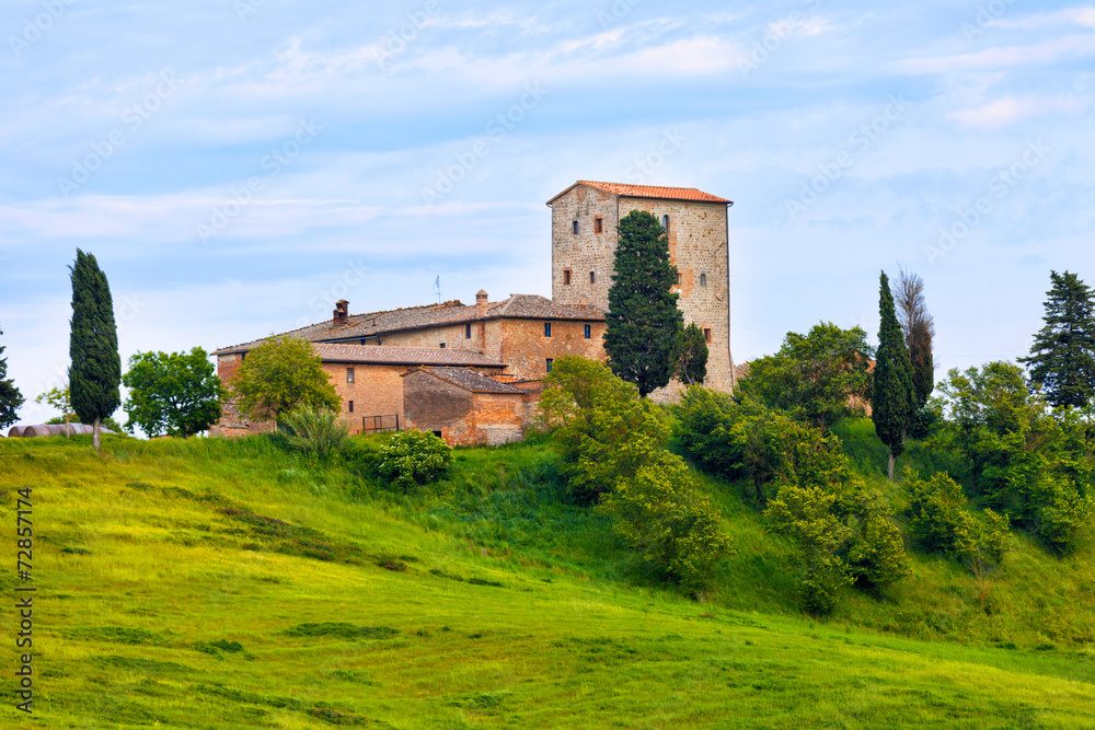 Big stone farmer house on green hill, Tuscany, Italy