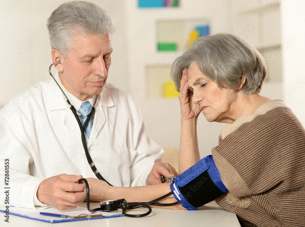 Fototapeta premium Elderly doctor measuring