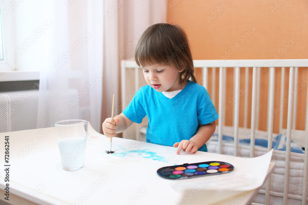 lovely little boy with brush and paints at home lovely little boy with brush and paints at home