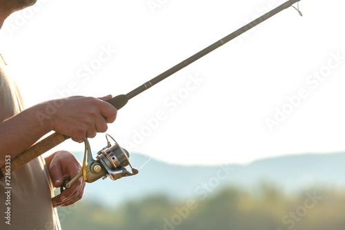 Modern clean fishing rod in hands