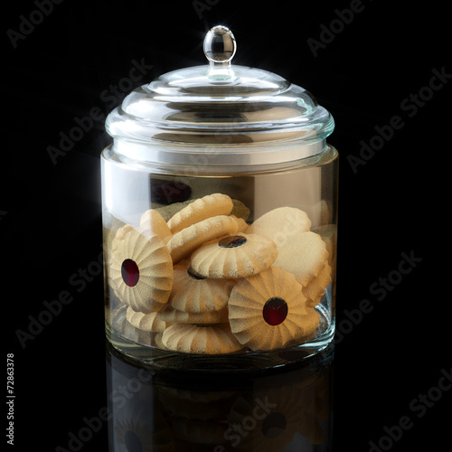 Fotografija Glass jar full of chocolate cookies on black background