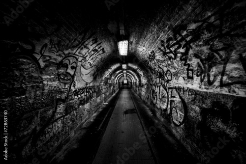 Dark undergorund passage with light photo