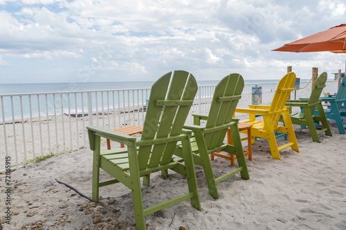 Colorful wooden chairs on the beach 