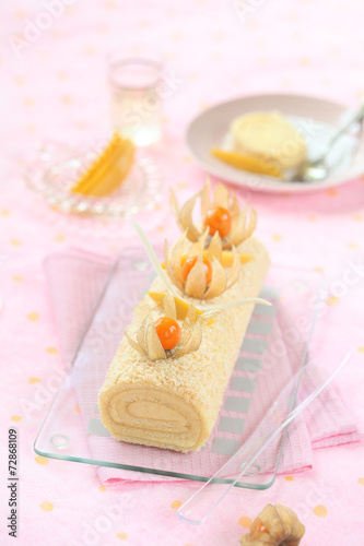 Fototapeta Naklejka Na Ścianę i Meble -  Tropical Swiss Roll Cake with Mango Cream Cheese Filling