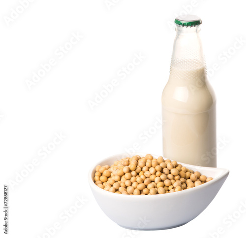 Soybean and bottles of soybean milk over white background