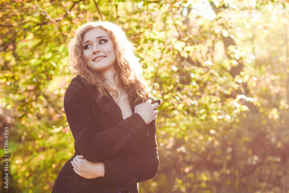 young blonde  woman  in park in autumn