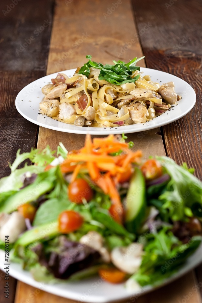 Chicken Pasta and Vegetable Salad Meal on Table