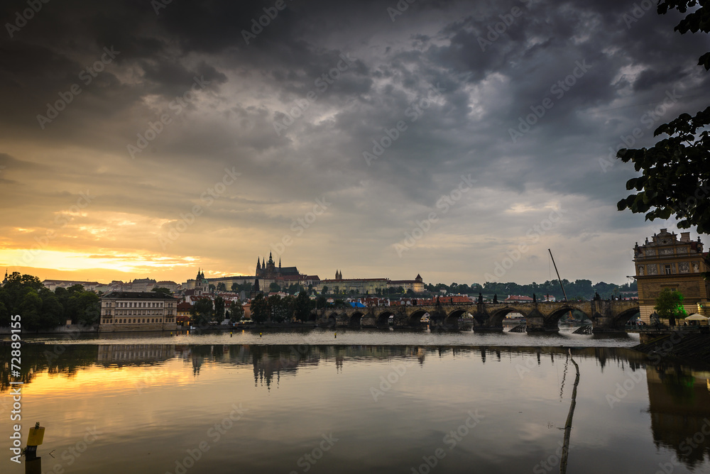 Vltava river and a Prague Castle at sunset ,Czech Republic .