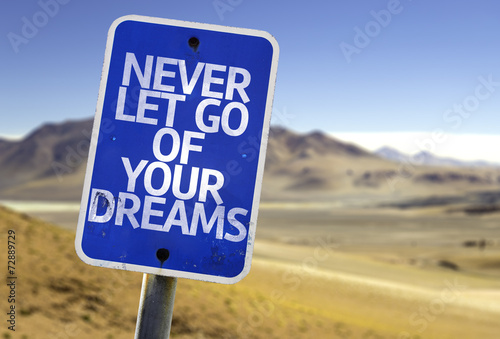 Never Let Go Of Your Dreams sign with a desert
