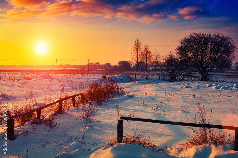 Winter snowy rural landscape at sunset