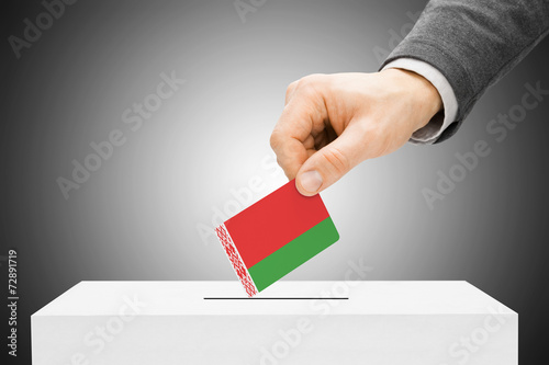 Voting concept - Male inserting flag into ballot box - Belarus photo