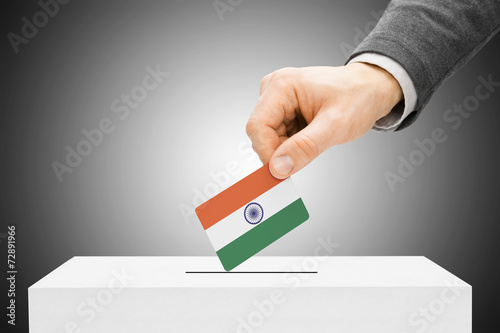 Voting concept - Male inserting flag into ballot box - India