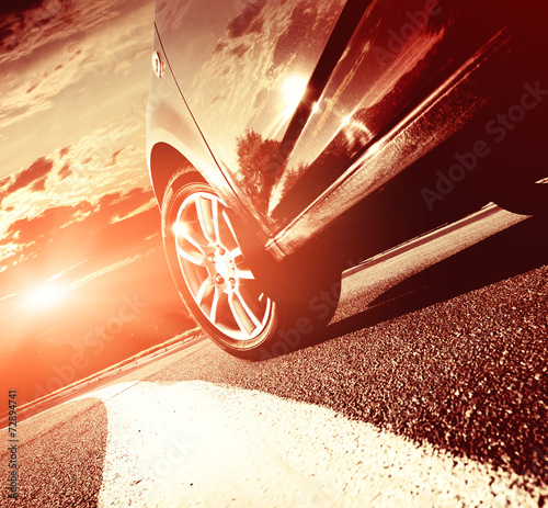 Car driving on a motorway at high speeds, overtaking other cars