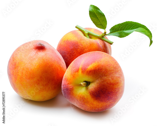 Peaches with leaves isolated on white background