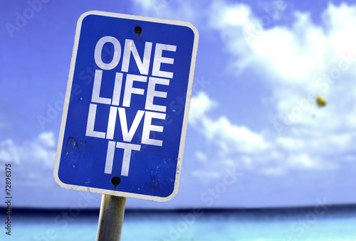 One Life Live It sign with a beach on background photo