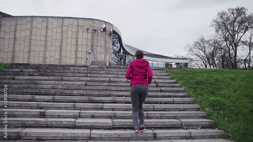 Woman jogging up the stairs in city Woman jogging up the stairs in city